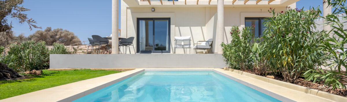 Außenansicht moderne Neubau-Villa in Cala Romàntica mit privatem Pool, Pergola-Terrasse und mediterranem Garten.