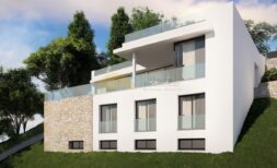 Modern new villa in Calvià with white facade, glass railings, natural stone details and terraced garden.