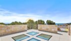 Dachterrasse der Neubau-Villa in Sol de Mallorca mit Glasböden, Natursteinmauern und Meerblick