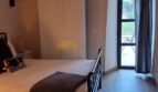 Schlafzimmer der Finca in Felanitx mit Gewölbedecke, Holzboden, Doppelbett und Terrassenzugang.