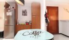 Küche mit Kühlschrank, Holzschränken und einem Tisch mit Coffee-Break-Aufdruck in Palma de Mallorca