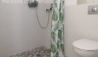 Modernes Badezimmer mit bodenebener Dusche, tropischem Duschvorhang und Wand-WC in Doppelhaushälfte Llucmajor