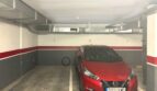 Tiefgarage mit nummerierten Stellplätzen und rotem Nissan Micra, Lüftungskanäle an der Decke, Palma de Mallorca