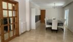 Elegantes Esszimmer mit Marmorboden, großem Esstisch und Holztür im Chalet Es Garrovers, Marratxí