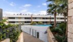 Modern residential complex in La Vileta with shared pool, palms and well-maintained outdoor facilities.