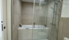 Modernes Badezimmer im Penthouse mit Glasdusche, Badewanne und beigen Fliesen in Palma de Mallorca.