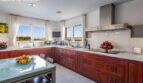Modern kitchen with wooden fronts and sea view in the chalet in Calvia – Puerto Adriano