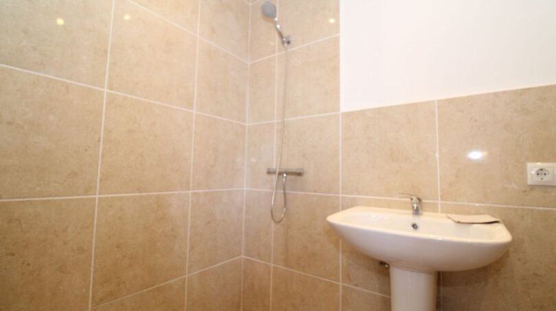 Badezimmer der Finca mit Dusche, Waschbecken und beigen Fliesen in Son Ferriol, Palma