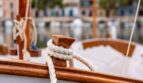 Wooden sailing boat with white rope in the Mediterranean harbor of Bendinat – pure Mediterranean flair.