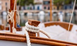 Wooden sailing boat with white rope in the Mediterranean harbor of Bendinat – pure Mediterranean flair.