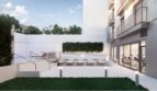 Modern outdoor terrace with pool, loungers, vertical garden and fitness room in Palma de Mallorca.