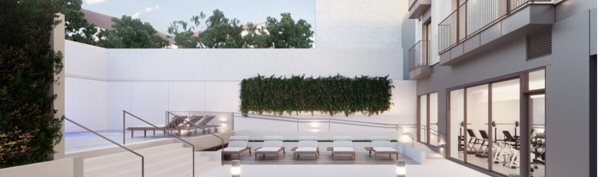 Modern outdoor area with pool, lounge chairs, green plant wall and fitness room of a penthouse in Palma