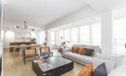 Helles Wohnzimmer mit grauem Sofa, Marmor-Couchtisch und offener Küche in modernisierter Palma-Wohnung.