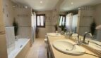 Elegantes Badezimmer mit Doppelwaschbecken, Badewanne und Dusche im Einfamilienhaus Llucmajor.