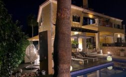 Villa de lujo en Llucmajor de noche con piscina iluminada, terraza soleada y elegante área exterior.