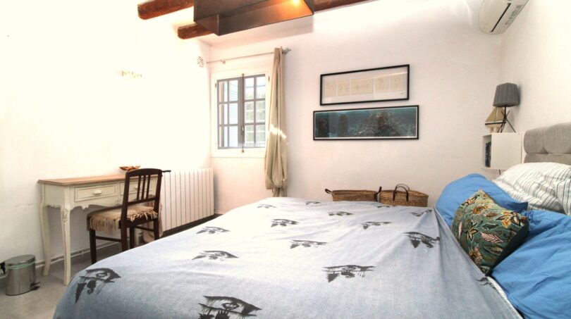 Schlafzimmer mit Doppelbett, Holzbalkendecke, Klimaanlage und rustikalem Charme in Bergimmobilie Esporles