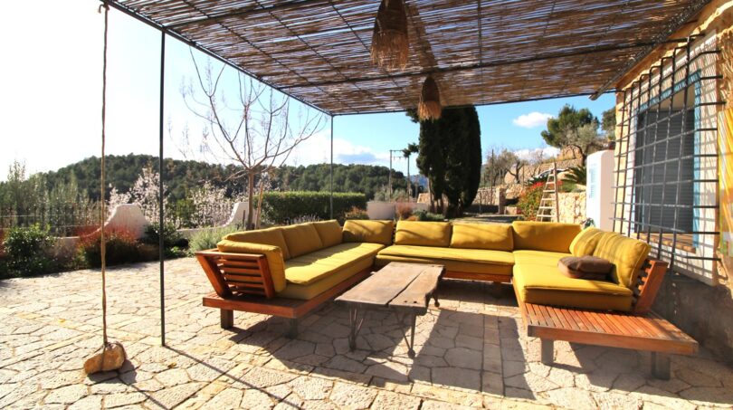 Überdachte Terrasse mit gelbem L-Sofa und Natursteinboden, Bergjuwel in Esporles