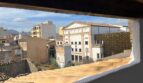 Dachfensterausblick auf historische Altstadt von Inca mit klassizistischem Theater und Terrakottadächern