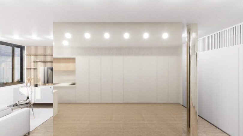 Modernes Loft in Palma: Helles Wohnzimmer mit Marmorboden, goldener Säule und eleganter Wandverkleidung.