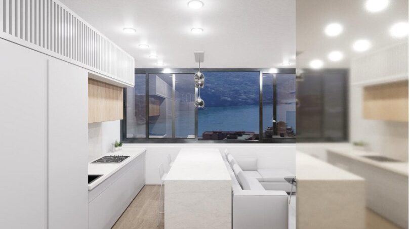 Modernes weißes Loft-Küche mit Kochinsel, Pendelleuchte und Panoramafenster mit Meerblick in Palma