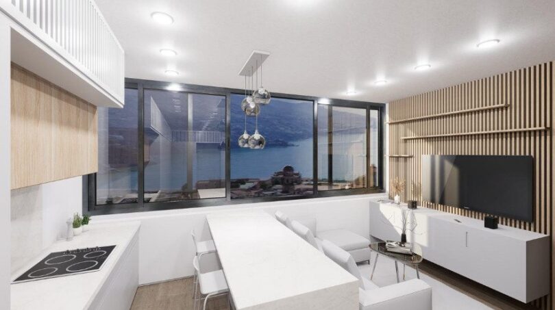 Modernes Loft in Palma: Offener Wohn-Küchenbereich mit Panoramafenster und Meerblick, helles Design.