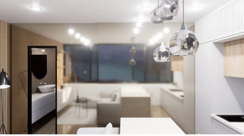 Modernes Loft-Wohnzimmer mit Küchenzeile, Pendelleuchten und Meerblick in Palma de Mallorca