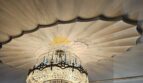 Eleganter Kristalllüster unter dekorativ gefältelter Decke im Stadthaus Inca