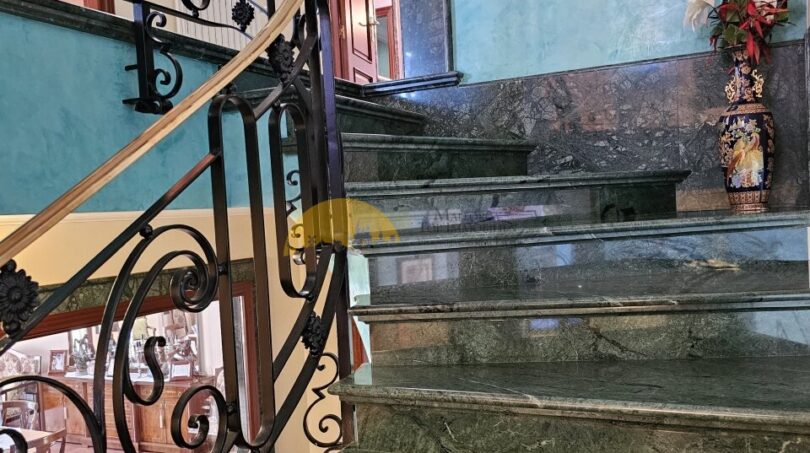 Elegant marble staircase with wrought iron railing in the historic town house in Inca