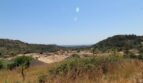 Vista panorámica de Mancor de la Vall con pueblo, colinas y vegetación mediterránea en ubicación rural tranquila.