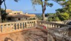 Sunny terrace with stone balustrade and sea view of the Mediterranean villa in Porto Cristo