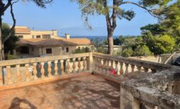 Sunny terrace with stone balustrade and sea view of the Mediterranean villa in Porto Cristo
