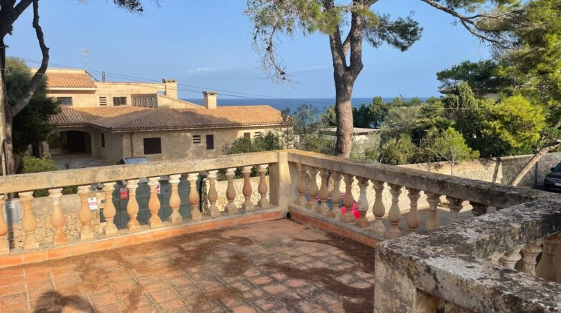 Sunny terrace with stone balustrade and sea view of the Mediterranean villa in Porto Cristo