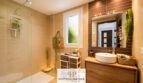 Modernes Badezimmer im Luxus-Chalet Cala Murada mit Glasdusche, Holzwaschtisch und maritimer Dekoration.