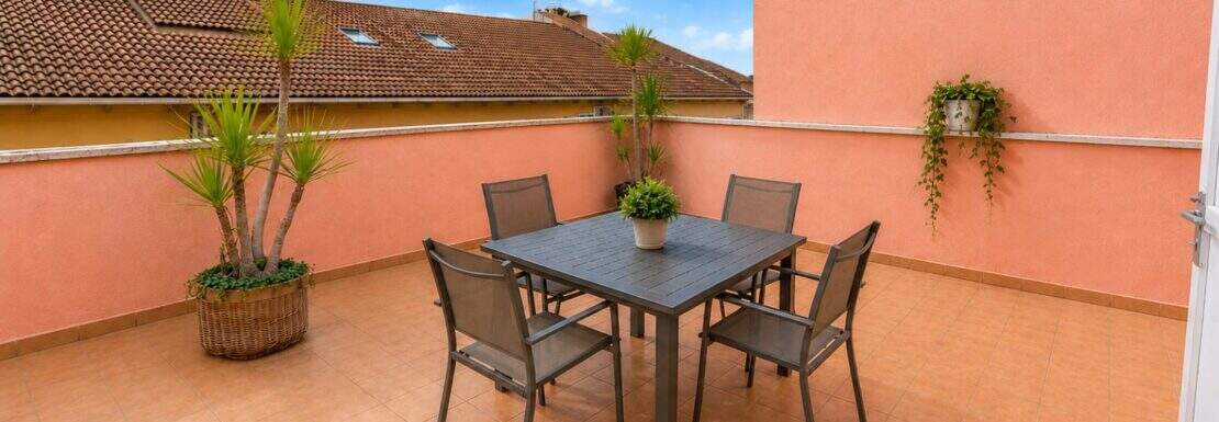 Large roof terrace of a penthouse in Inca Mallorca with dining area and Mediterranean ambience
