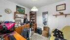 Study with a desk, gaming chair, bookshelf, and sofa in the house in Felanitx
