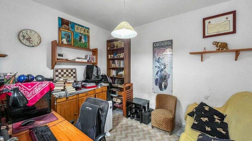 Study with a desk, gaming chair, bookshelf, and sofa in the house in Felanitx
