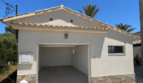 Detached garage building of the Majorcan villa in Manacor with Mediterranean tile roof and natural stone cladding