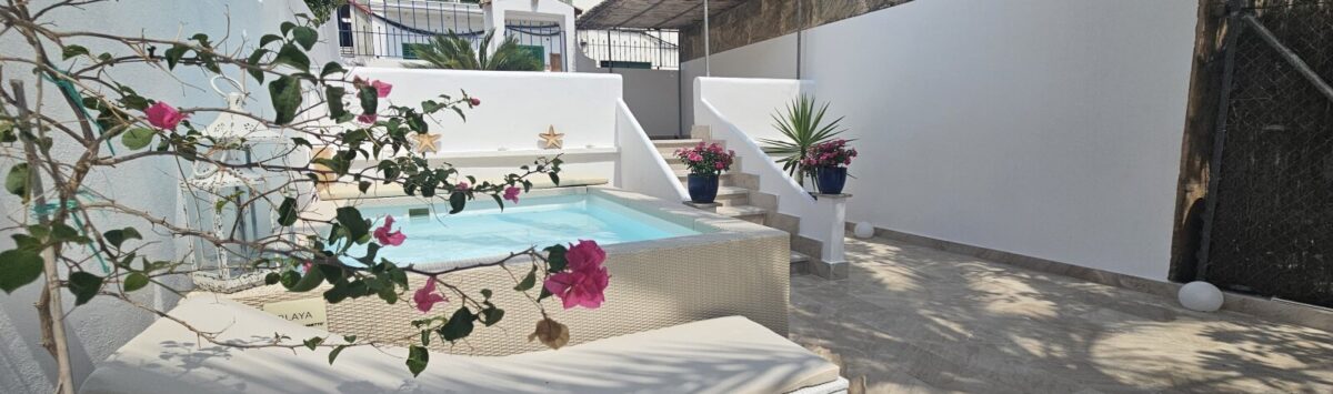 Sunny terrace with small pool, sun loungers and bougainvillea in modern apartment in Portocolom