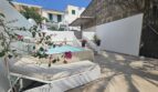 Sunny terrace with small pool, sun loungers and bougainvillea in modern apartment in Portocolom