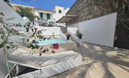 Sunny terrace with small pool, sun loungers and bougainvillea in modern apartment in Portocolom