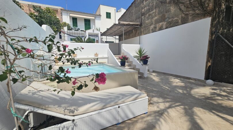 Sunny terrace with small pool, sun loungers and bougainvillea in modern apartment in Portocolom