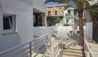 Terrace with jacuzzi, palm tree and staircase of a modern apartment in Portocolom, Mallorca
