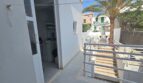 Balcony with utility room, white railing and palm tree in modern apartment in Portocolom