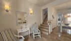 Bright entrance area with marble staircase, rocking chairs and mirror in Mediterranean style, Portocolom apartment