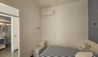 Bright bedroom with double bed, air conditioning and en-suite bathroom in modern apartment in Portocolom