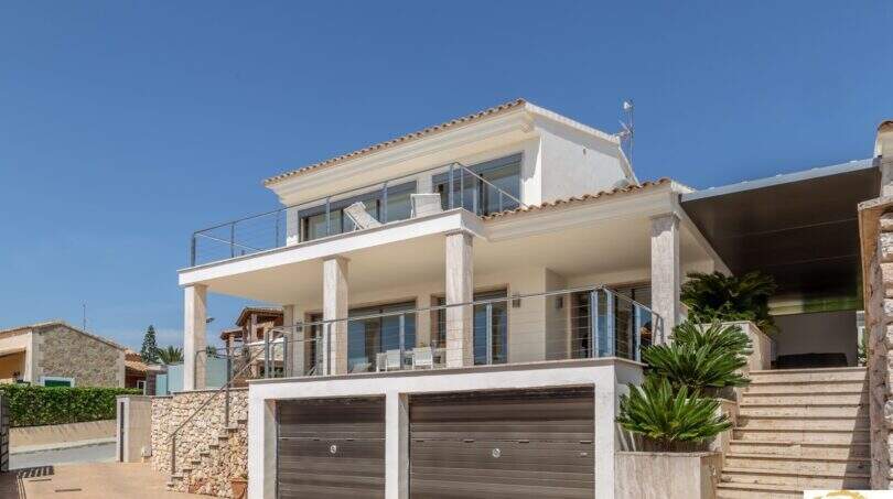 Vista exterior: Villa de lujo mediterránea en Porto Cristo con garaje doble, balcón de cristal y terraza en primera línea de mar