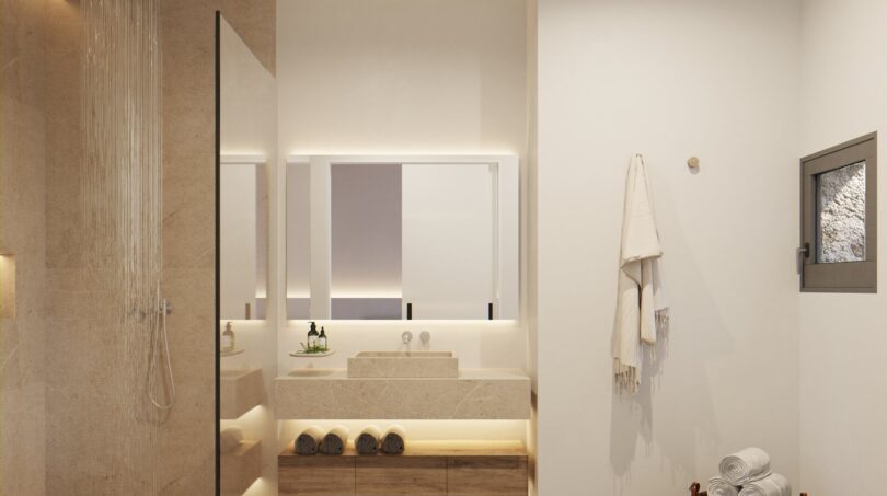 Modernes Badezimmer der Neubau-Finca in Artà mit Regendusche, Naturstein und mediterranem Ambiente.