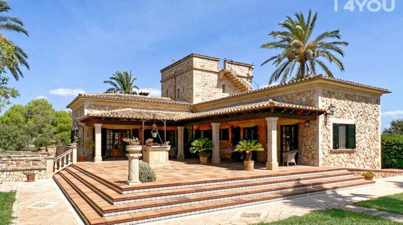 Außenansicht exklusive Finca in Colònia de Sant Jordi: Natursteinvilla mit Säulentetrasse, Brunnen und Palmen