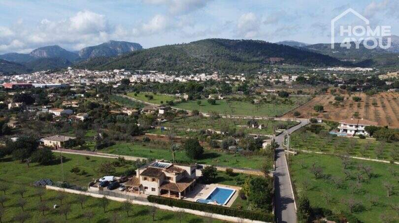 Luftaufnahme mallorquinischer Villa in Lloseta mit Pool, Solaranlage & Blick auf Tramuntana-Gebirge.