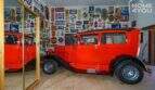 Garage der Finca mit rotem Oldtimer und nostalgischen Werbeschildern an der Wand